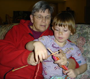 Martha teaches Alisha to knit